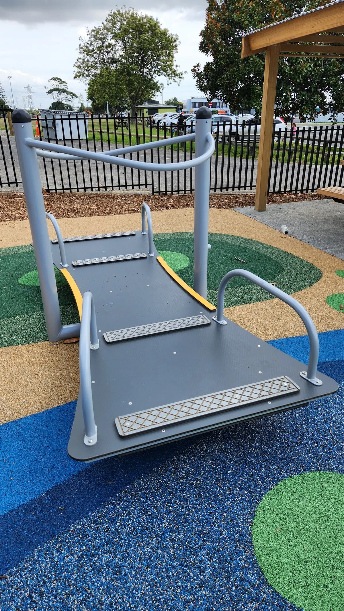 Rocking platform on coloured rubber surfacing at Ti Rakau Park playground, Pakuranga