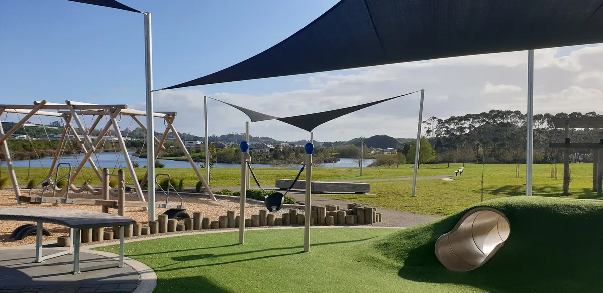 Climbing frame, shade sails and lake view at The Lakes Playground, Pyes Pa