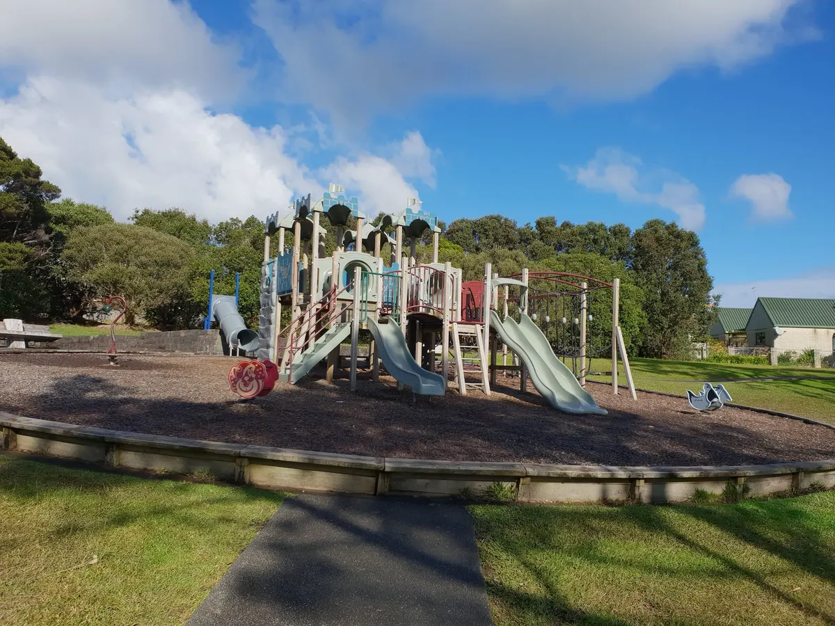Slides and multi-play castle structure at Luckens Reserve playground, West Harbour