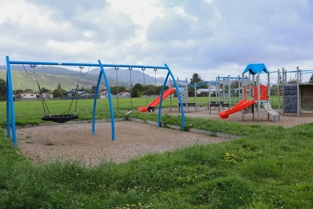 Basket swing and multi-play structure with slides at Pohutukawa Park playground, Paraparaumu