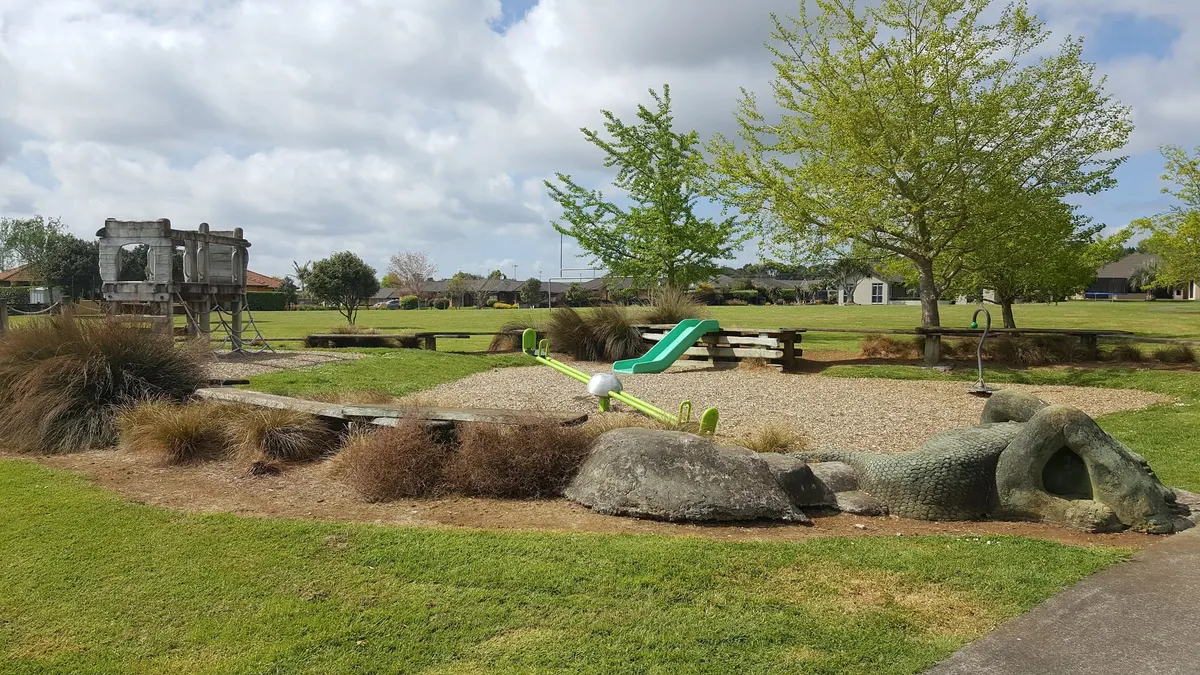 See-saw, slide and animal statue beside the fort at O'Connor Drive playground, Pukekohe