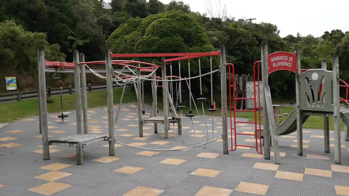 Rope climbing frame, slide and spinning seats at Warwick Street playground, Wilton