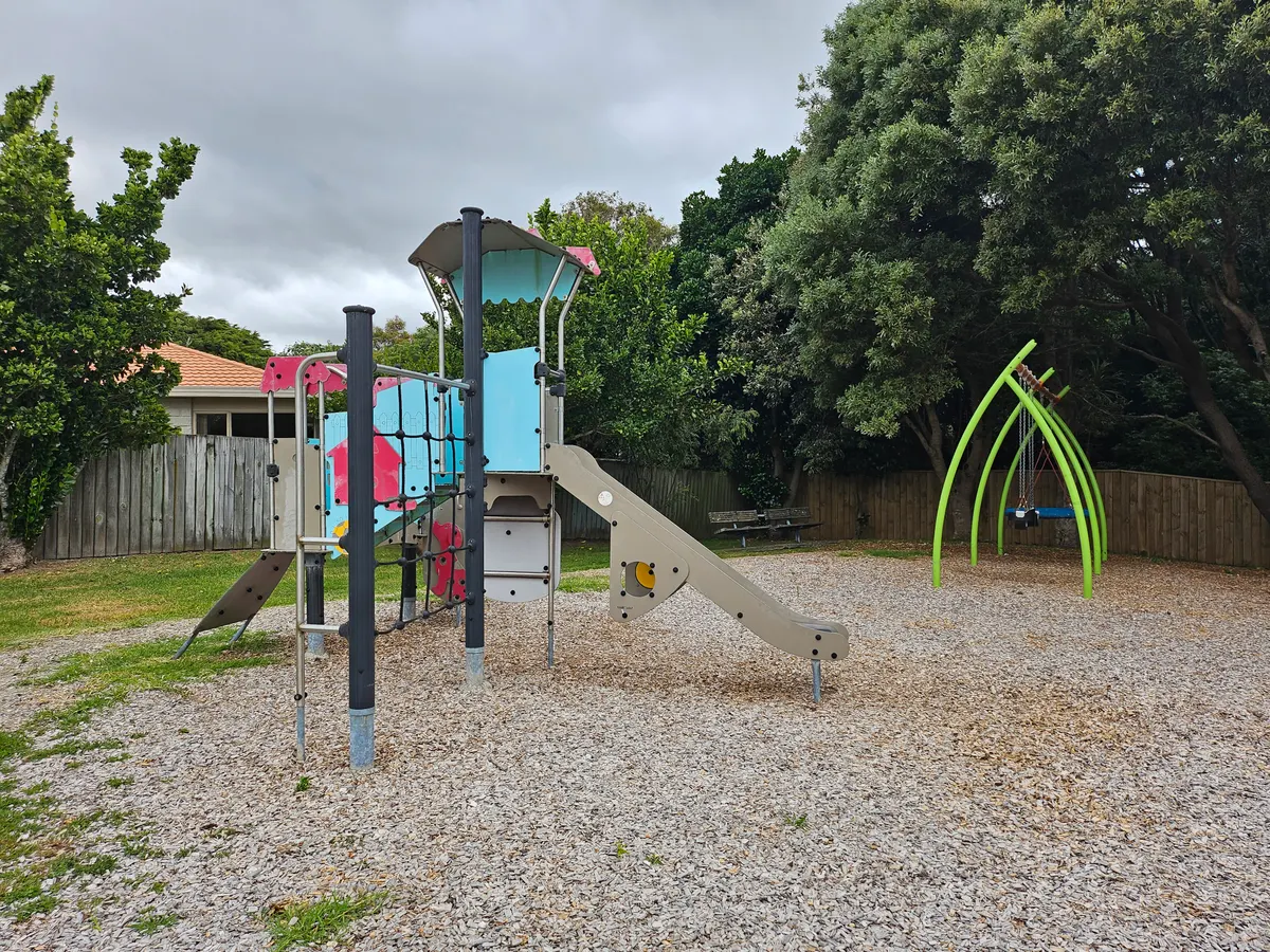 Junior play tower with slide and arched swings at Elizabeth Rose Reserve playground, Paraparaumu