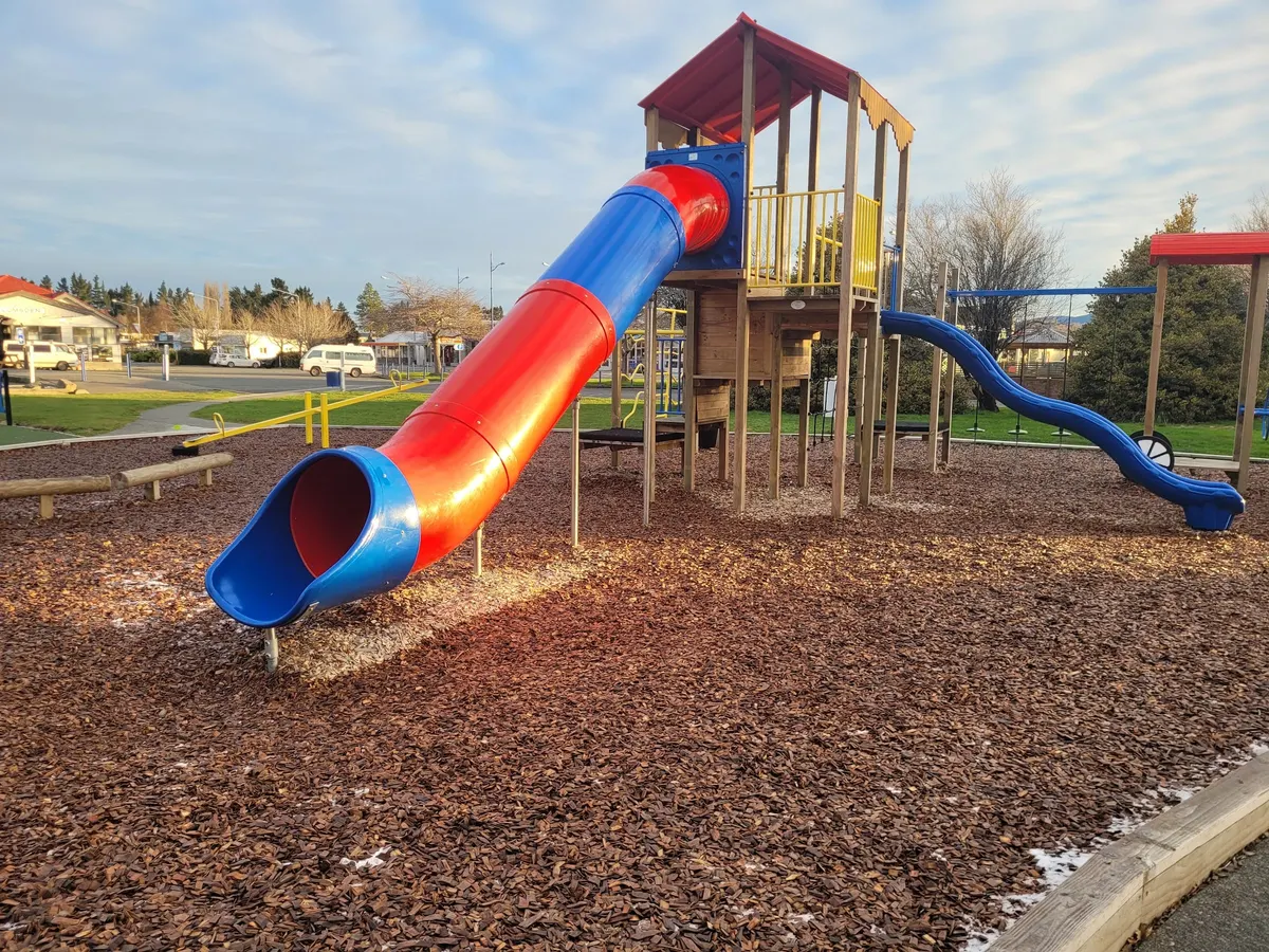 Red and blue tube slide on a tower at Lumsden playground, Southland