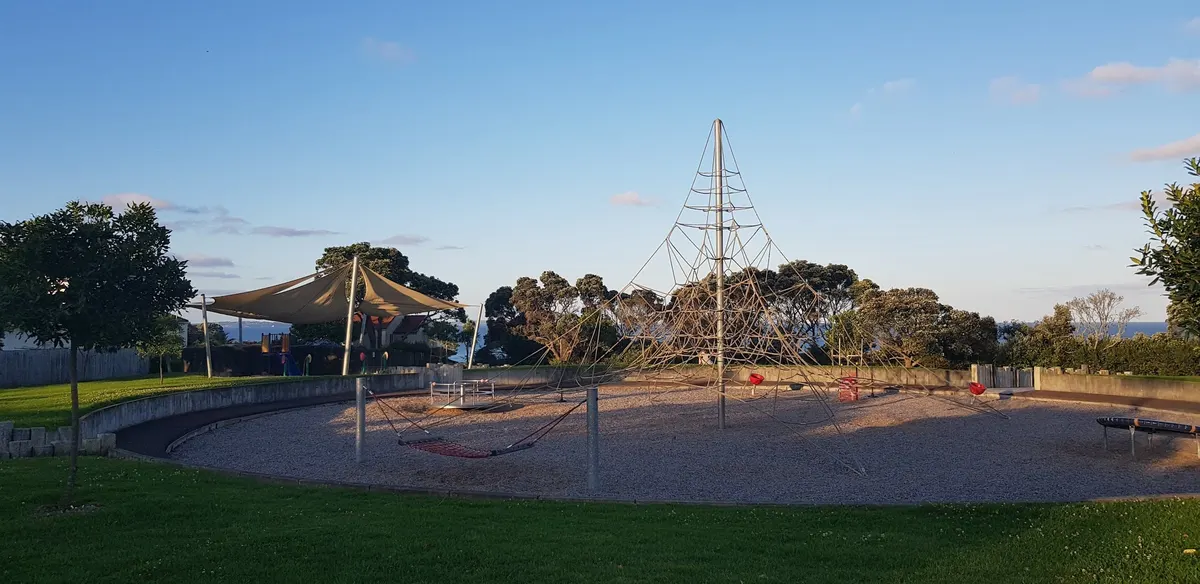 Rope climbing web and shade sails across the play area at Kennedy Park playground, Castor Bay
