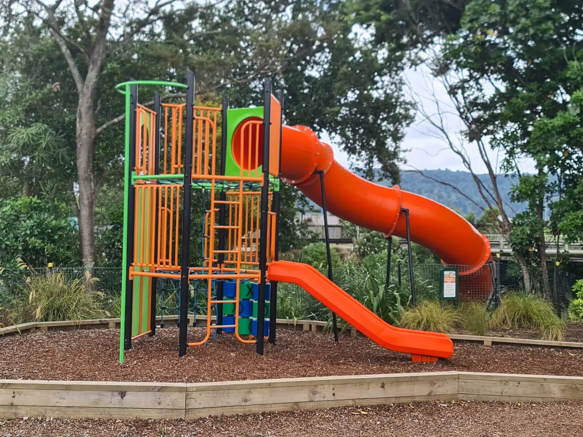 Orange tower with spiral tube slide on bark at Ohakune Carrot Mennesson Adventure Park playground