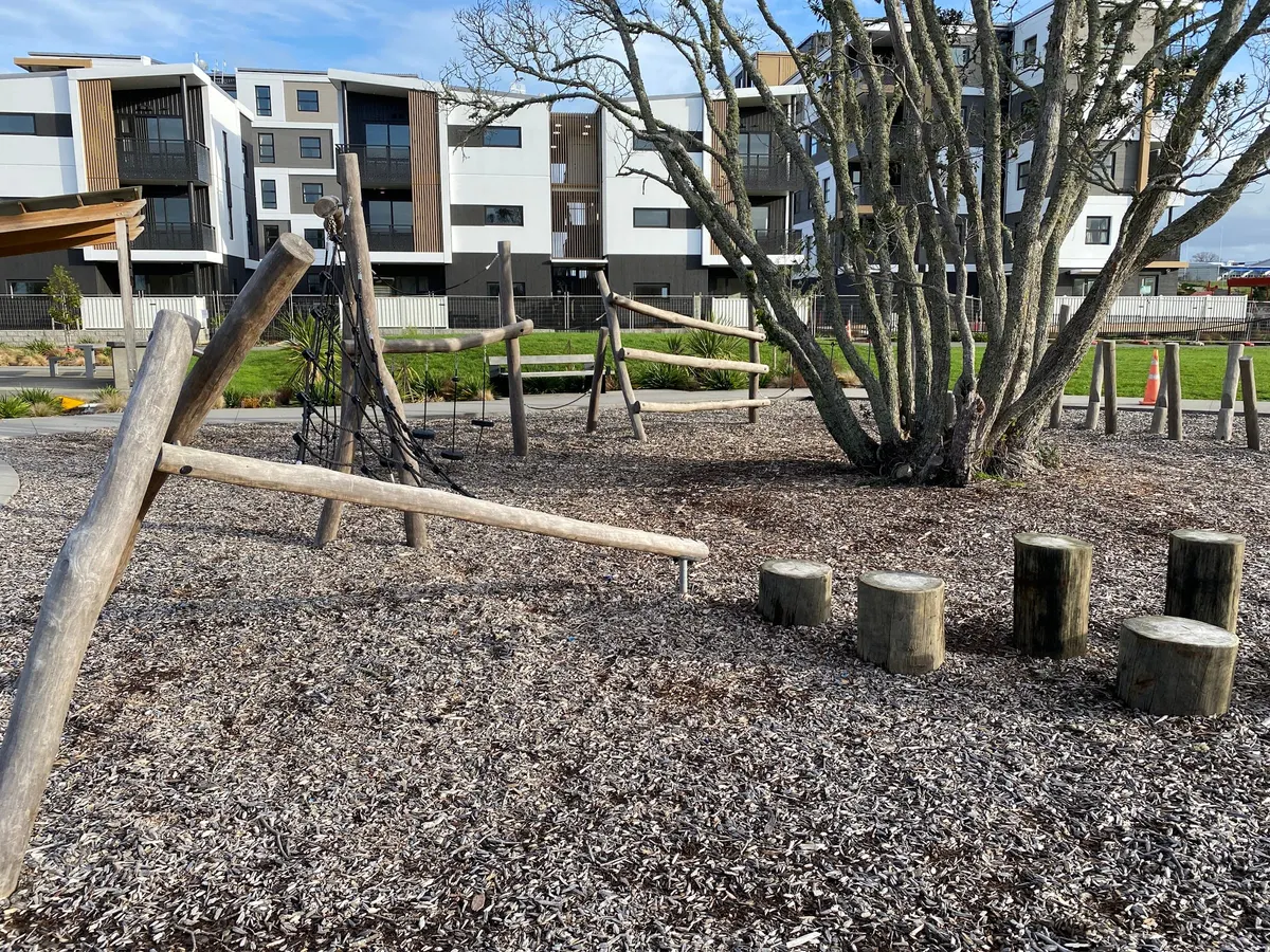 Log balance beams, stump stepping stones and climbing net at Northcote playground on Cadness Street