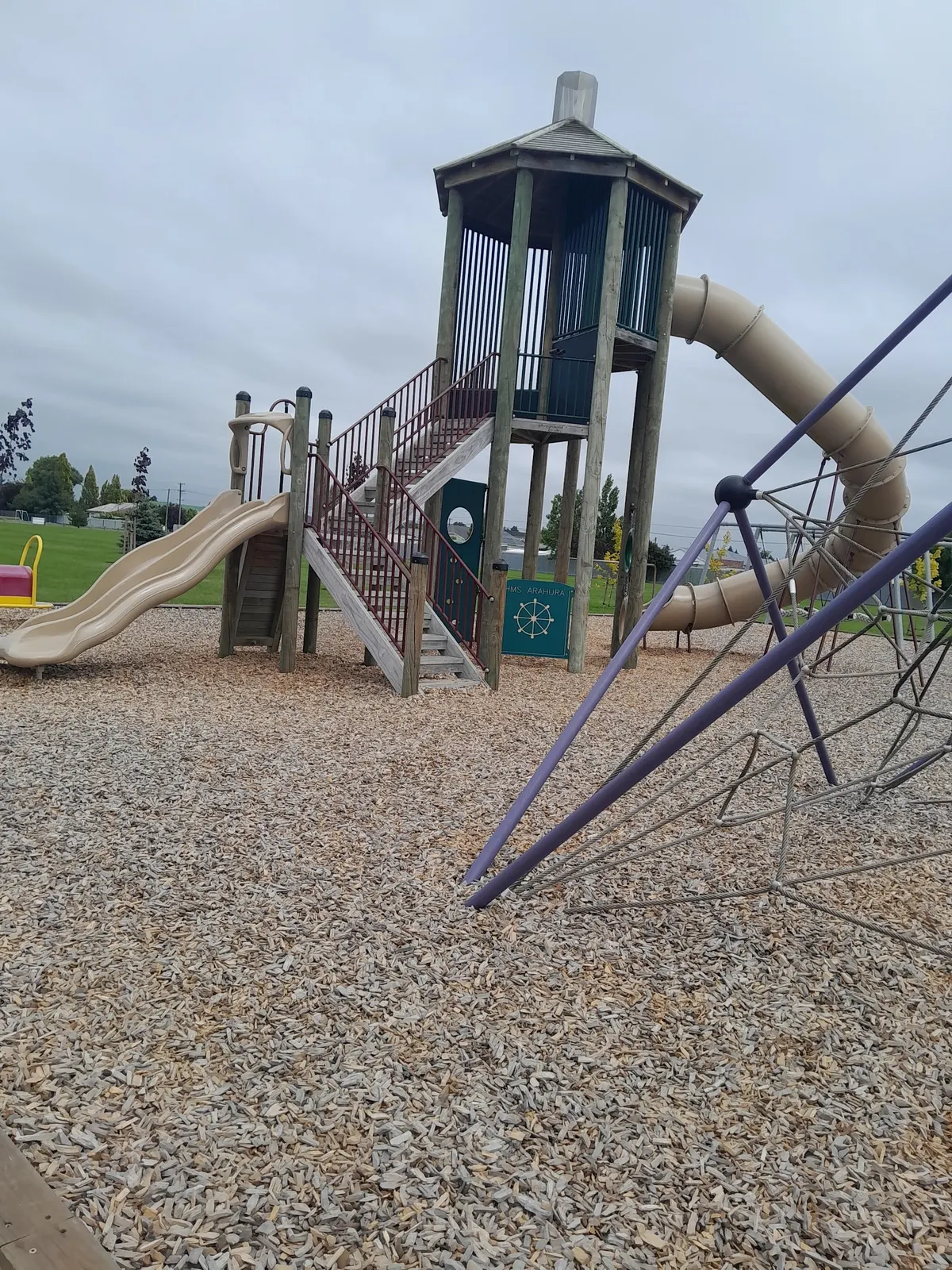 Tower with tube slide, wavy slide and rope climbing net at George Glassey Park playground, Tinwald