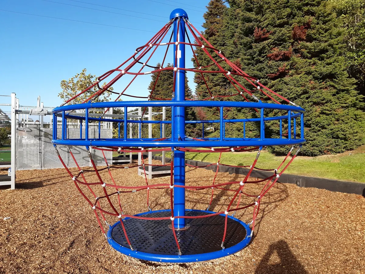 Rope net spinner on bark chip at Keith Hay Park playground, Mount Roskill, Auckland
