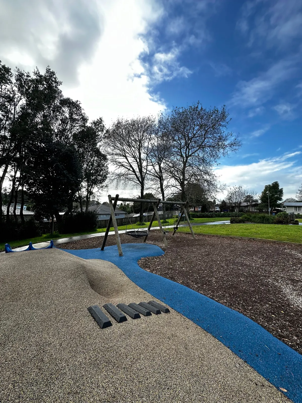 Basket swing and rubber-surfaced mound with stepping blocks at Te Po Roa Reserve playground, Gate Pa, Tauranga