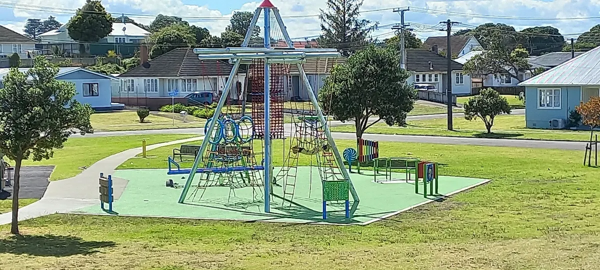 Rope climbing pyramid on green rubber surfacing at Lorenzdale Park playground, Gonville, Whanganui