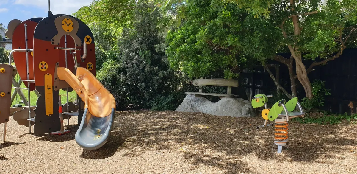 Orange slide on the junior play tower and a spring rocker at Salisbury Reserve playground, Herne Bay