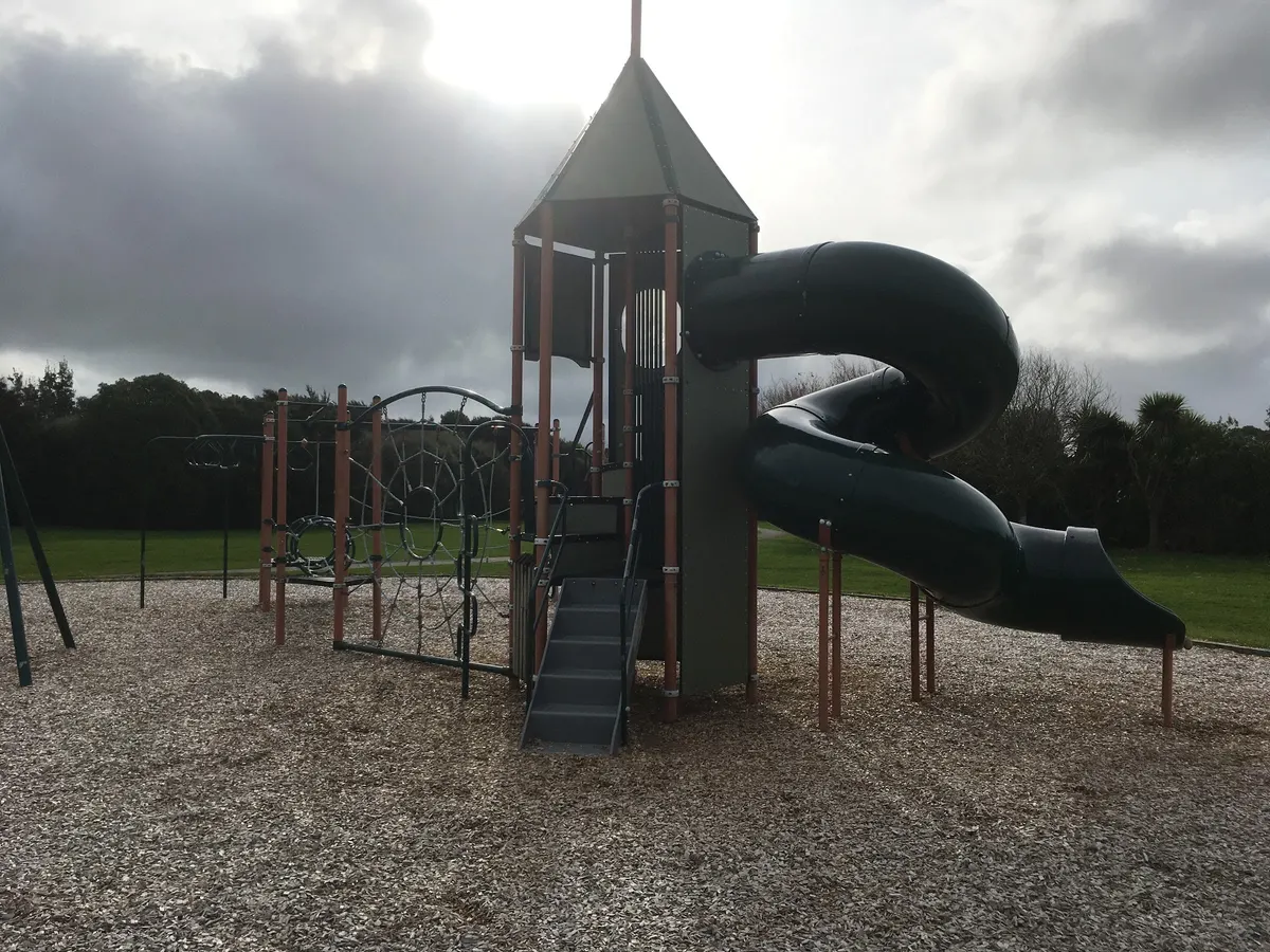 Climbing tower with spiral tube slide on bark at Waterstone Reserve playground, Paraparaumu