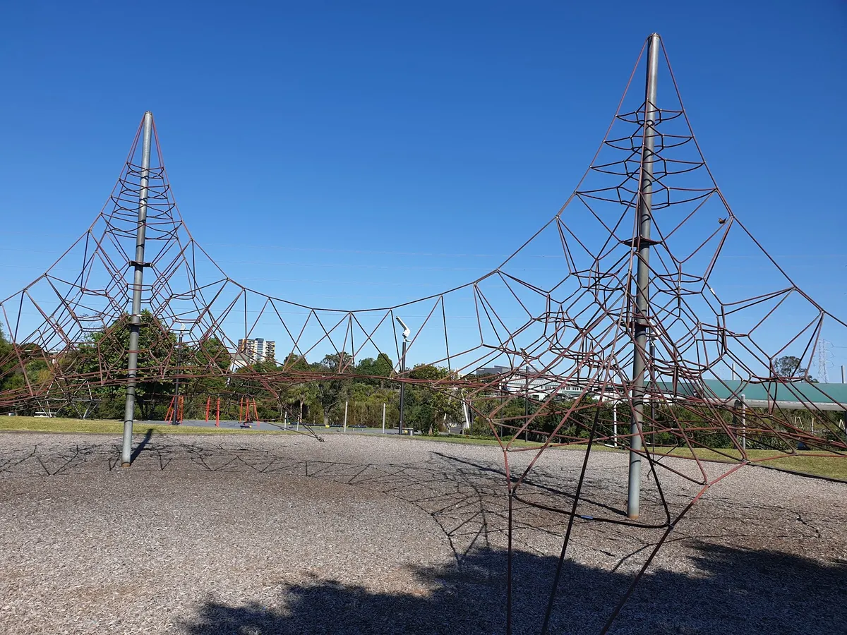 Two tall rope-net climbing towers at Te Kotuitanga Olympic Park playground, Blockhouse Bay