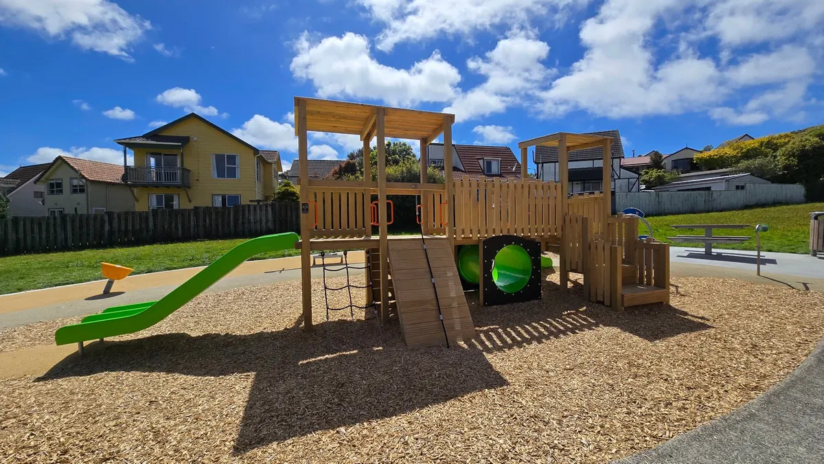 Timber play tower with slide and tunnel at Churton Park Reserve playground, Wellington