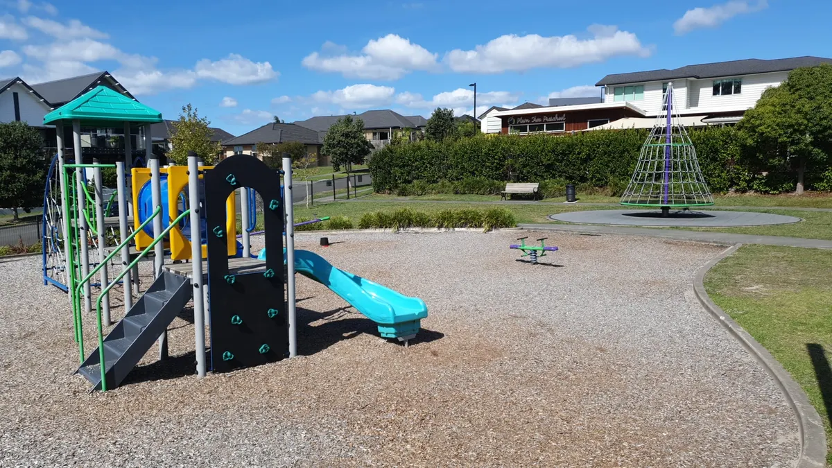 Junior climbing frame, rotonet and see-saw at Botanical Drive Park playground, Millwater