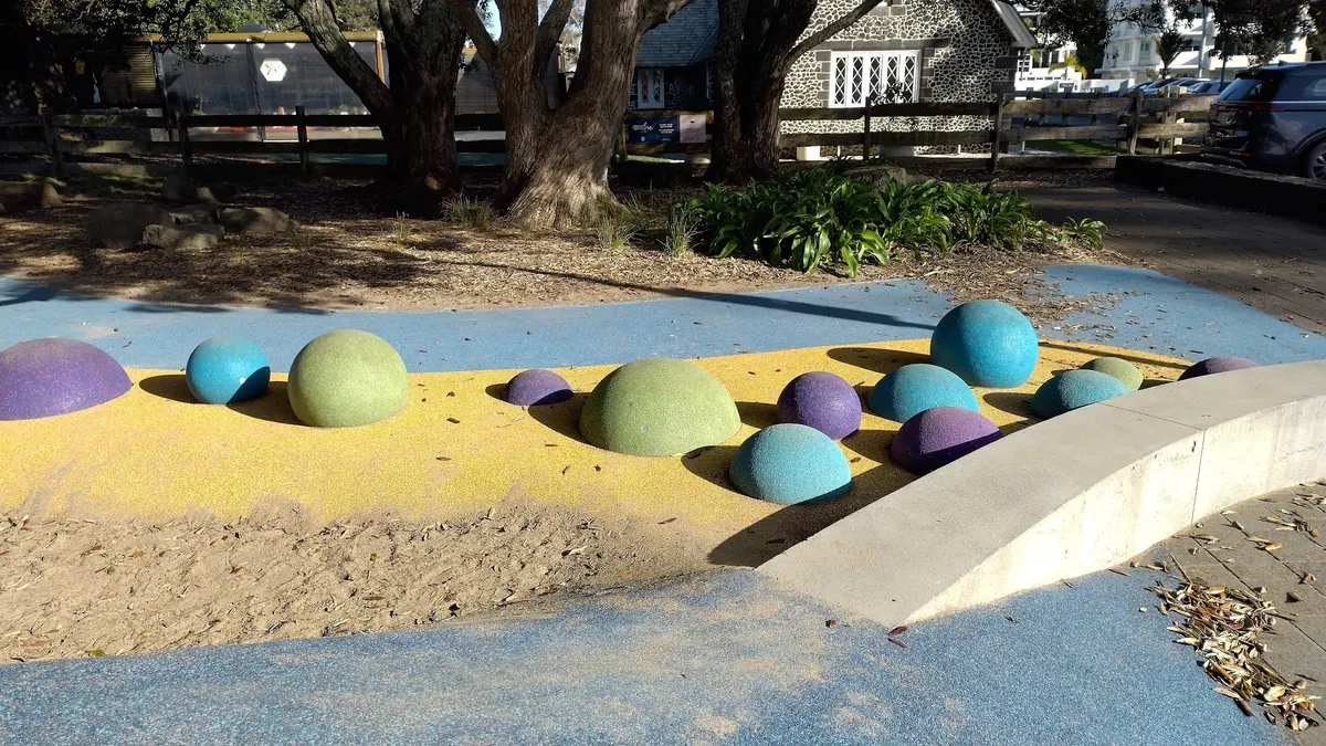 Coloured rubber mounds and sand play area at Selwyn Reserve playground, Mission Bay