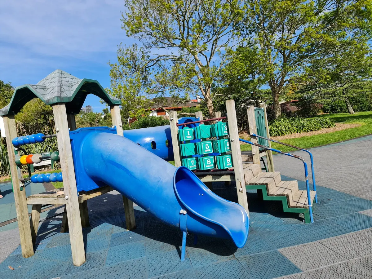 Blue tube slide and junior multi-play structure at Hart Domain playground, Henderson